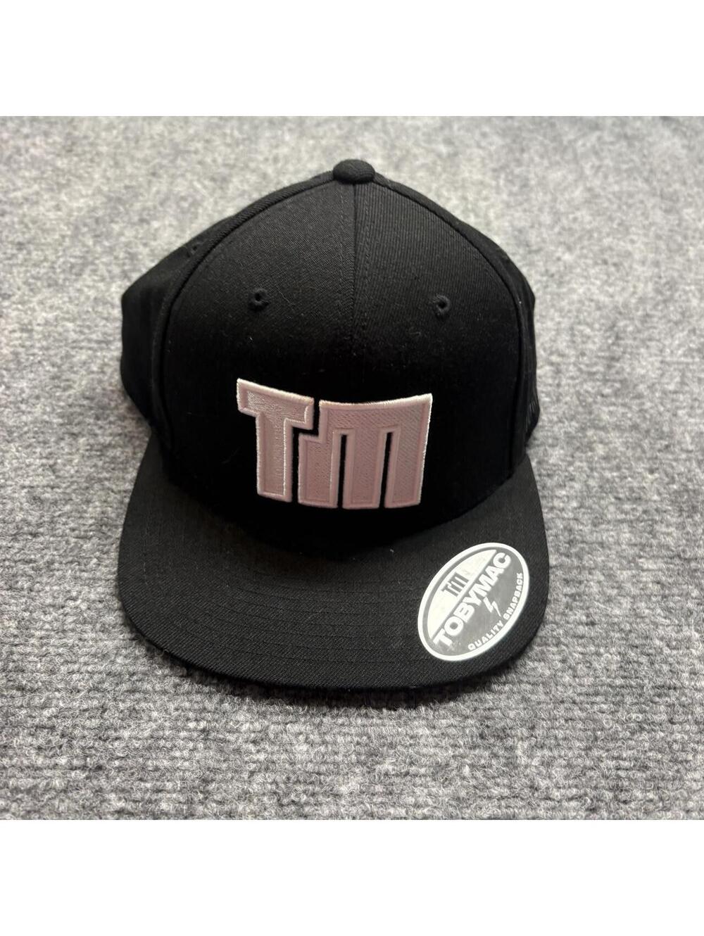 Tobymac black snapback hat with pink 'TM' logo
